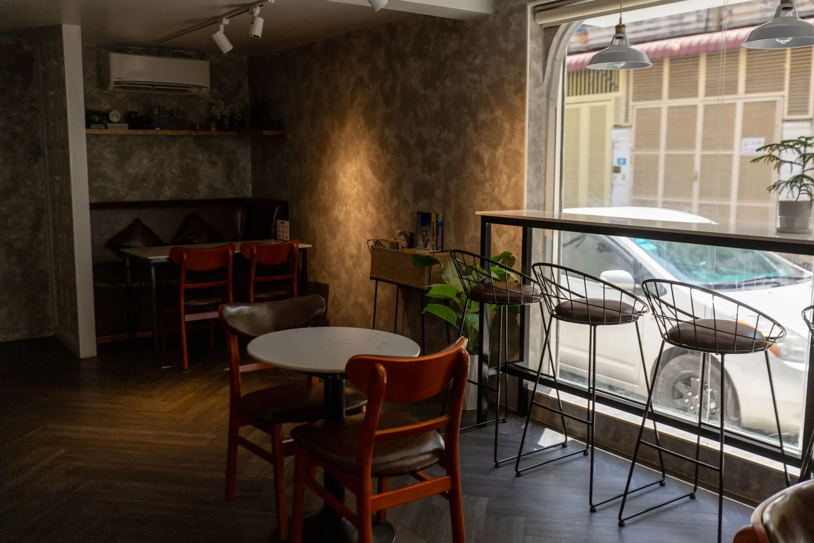 Tables and chairs beside a bright window